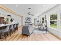 Bright living area with modern furnishings, wooden floors, and large windows at 6531 2Nd N Ave, St Petersburg, FL 33710