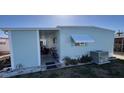 Side exterior of home with covered porch and AC unit outside at 665 54Th S St # 133, Gulfport, FL 33707