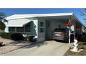 Charming single-story home with a carport, well-kept landscaping, and a car parked on the driveway at 665 54Th S St # 133, Gulfport, FL 33707