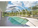 Sparkling screened-in pool and outdoor patio area with beautiful landscaping and privacy at 6968 De Brita Rd, North Port, FL 34291