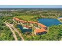 Aerial view of lakefront condominium complex with pool at 7710 Lake Vista Ct # 205, Lakewood Ranch, FL 34202
