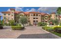 Beautiful condo community featuring lush landscaping and stunning architecture with a brick drive at 7710 Lake Vista Ct # 205, Lakewood Ranch, FL 34202