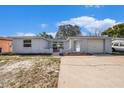 Charming single-story home with a well-maintained exterior and a large driveway at 7814 Chalafonte Dr, Port Richey, FL 34668