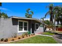 Charming home exterior with well-maintained landscaping and a welcoming entrance under a bright blue sky at 11233 51St N Ave, St Petersburg, FL 33708