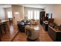 Spacious living room features hardwood floors, comfortable seating, and ample natural light from shuttered windows at 11233 51St N Ave, St Petersburg, FL 33708