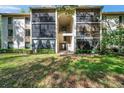 Building featuring two stories with an exterior staircase and walkway at 1398 Shady Pine Way # H2, Tarpon Springs, FL 34688