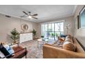 Cozy living room featuring stylish decor, natural light, and access to an outdoor balcony at 1398 Shady Pine Way # H2, Tarpon Springs, FL 34688