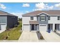 This home boasts an attached garage, manicured lawn, and sidewalk at 1869 Hovenweep Rd, Wesley Chapel, FL 33543