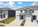 The home has an attached garage, sidewalk, and lush lawn at 1869 Hovenweep Rd, Wesley Chapel, FL 33543