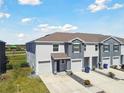 This is an aerial view of the homes with well-maintained lawns at 1869 Hovenweep Rd, Wesley Chapel, FL 33543