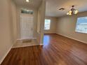Inviting foyer with tile flooring, flowing into a spacious living area featuring hardwood floors at 200 Fairmont Dr, Spring Hill, FL 34609