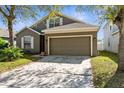 Well-manicured single Gathering home featuring a two-car garage and a concrete driveway at 200 Fairmont Dr, Spring Hill, FL 34609