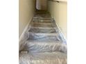 Carpeted stairway completely protected in plastic wrap at 2061 Fiesta Ridge Ct, Tampa, FL 33604