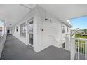 Hallway leading to a condo with a private balcony overlooking the complex at 2428 Columbia Dr # 72, Clearwater, FL 33763