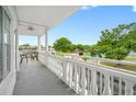 Balcony featuring decorative railings with a view of tree lined grounds at 2428 Columbia Dr # 72, Clearwater, FL 33763