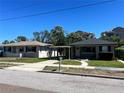 Street view of two single-story homes, featuring a carport and cozy design at 3503 Casablanca Ave, St Pete Beach, FL 33706