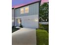 A modern two-story townhome with a one car garage and a well maintained lawn at 4326 Banjo Lake Rd, Land O Lakes, FL 34639