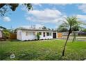 Charming single-story home with a blacktop driveway and a lush green lawn at 4601 71St N Ave, Pinellas Park, FL 33781
