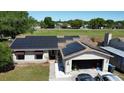 Birds eye view of the house with solar panels, spacious yard, and an attached two car garage at 520 Oak Creek Dr, Brandon, FL 33511