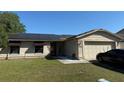 Charming single-story home with solar panels, attached two car garage, and well maintained lawn at 520 Oak Creek Dr, Brandon, FL 33511