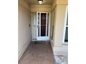 Covered entryway with a brown door, tiled floor, and a white metal security door at 520 Oak Creek Dr, Brandon, FL 33511