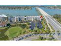 Aerial view of condo complex with lush landscaping, convenient parking, bridge view, and partial view of the golf course at 5701 Bahia Del Mar Cir # 408, St Petersburg, FL 33715