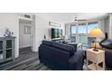 Comfortable living room featuring water views, stylish decor, and an open layout that flows to the balcony at 5701 Bahia Del Mar Cir # 408, St Petersburg, FL 33715