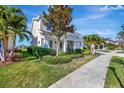 Charming two-story home with a well-maintained lawn and beautiful landscaping at 6324 Brevada Ln, Apollo Beach, FL 33572