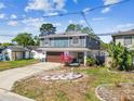 Charming two-story home featuring a well-maintained lawn and an attached garage at 6680 67Th N Way, Pinellas Park, FL 33781