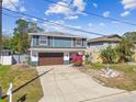 Charming two-story home featuring a well-maintained lawn and an attached garage at 6680 67Th N Way, Pinellas Park, FL 33781