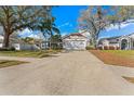 Inviting single-story home with a spacious driveway, attached garage, and a well-kept lawn in a friendly neighborhood at 968 Edgehill Dr, Palm Harbor, FL 34684