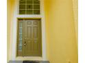 A solid olive colored front door provides privacy to your new home at 12720 Whitney Meadow Way, Riverview, FL 33578