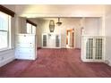 Bright and airy living room featuring stylish built-in cabinets and pink carpet at 160 16Th Ne Ave, St Petersburg, FL 33704