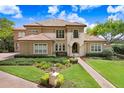 View of this home's exterior, showing mature landscaping and beautiful architectural details at 17111 Journeys End Dr, Odessa, FL 33556