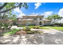 Lovely view of this home's exterior, showing driveway and manicured lawn at 17111 Journeys End Dr, Odessa, FL 33556