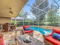 Inviting screened-in pool area with comfortable seating, perfect for outdoor relaxation and entertaining at 17503 Edinburgh Dr, Tampa, FL 33647