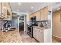 Kitchen with stainless steel appliances, granite counters, tile floors, and views of the dining area at 2700 Cove Cay Dr # 5-G, Clearwater, FL 33760