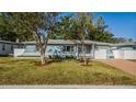 Lovely single-story home with a well-manicured lawn and mature trees in a quiet neighborhood at 2736 45Th N Way, St Petersburg, FL 33713