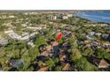 Aerial view of a home surrounded by lush trees and located near a beautiful blue water source at 2934 Lichen Ln # D, Clearwater, FL 33760