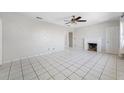 Bright living room with tile flooring, ceiling fan, and a decorative fireplace at 3310 W Swann Ave, Tampa, FL 33609