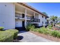 Exterior view of a condo featuring an entrance with covered staircases and walkways at 5019 Mill Pond Rd # 3128, Wesley Chapel, FL 33543