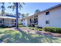 Well-maintained condo building with mature trees and manicured landscaping at 5019 Mill Pond Rd # 3128, Wesley Chapel, FL 33543