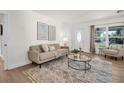 Inviting living room featuring neutral tones, modern decor and natural light from the entry door and windows at 5801 Dartmouth N Ave, St Petersburg, FL 33710