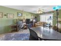 A living room featuring carpet, natural light and a desk at 5820 N Church Ave # 148, Tampa, FL 33614