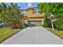 Charming two-story home featuring a well-maintained lawn and a spacious two-car garage at 6338 Springline Pl, Apollo Beach, FL 33572
