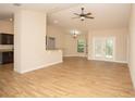 Spacious living room with wood floors and a view of the backyard through French doors at 6527 Grapewood Rd, Spring Hill, FL 34609