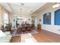 A dining room with dark wood floors, a dark wood table, and an archway into the kitchen at 8404 White Poplar Dr, Riverview, FL 33578