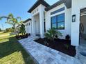 Charming single-story home with well manicured landscaping and a paver walkway at 9514 Snapper Cir, Port Charlotte, FL 33981
