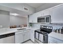Updated kitchen featuring stainless steel appliances, white cabinets, and modern countertops at 9526 Newdale Way # 101, Riverview, FL 33578