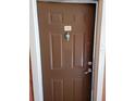 Brown front door with silver door knocker and unit number 235 at 10200 Gandy N Blvd # 235, St Petersburg, FL 33702